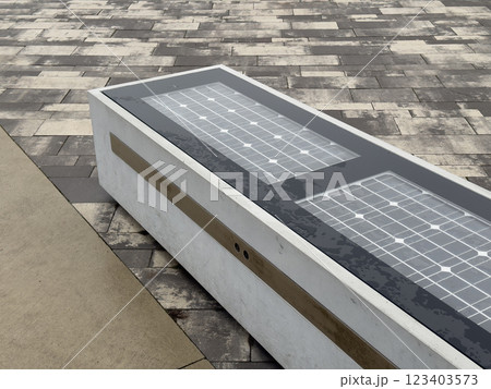 Modern urban solar-powered smart bench on tiled pavement Modern urban solar-powered smart bench on tiled pavement 123403573