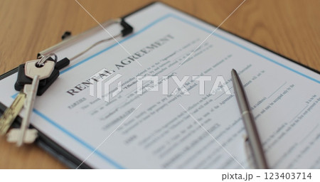 Close-up view of a lease agreement document with key, and a pen placed on top. Property rental, leasing contracts, real estate. 123403714