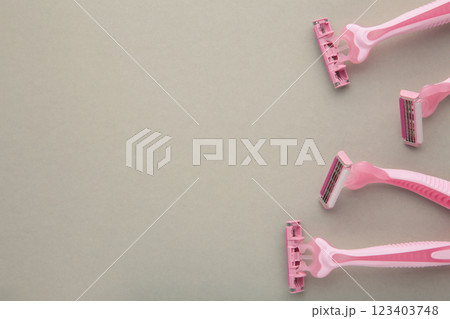 Pink razors for hair removal on grey background 123403748