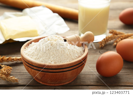 Ingredients for baking or cooking, egg flour, rolling pin butter, milk on a grey wooden background Cookie pie or cake recipe. Ingredients for baking or cooking, egg flour, rolling pin butter, milk on a grey wooden background Cookie pie or cake recipe. 123403771
