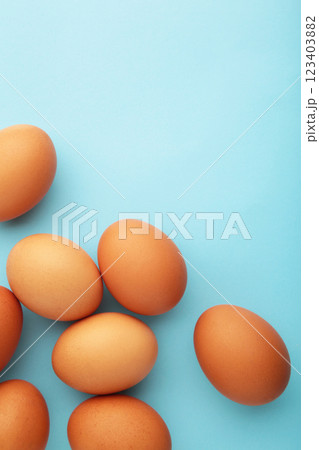 Chicken eggs on yellow background. Farm products, natural eggs. Vertical photo 123403882