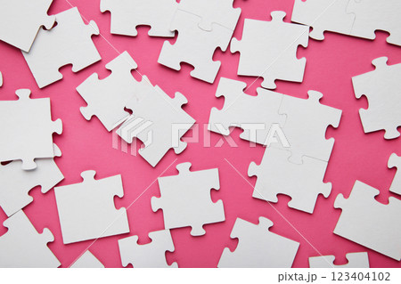 Close-up of a pile of uncompleted elements of a white puzzle. A huge number of rectangular pieces from one large white mosaic 123404102