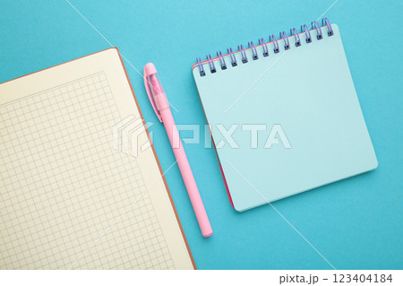 Open notebook and notebooks on blue background. Open notebook and notebooks on blue background. 123404184