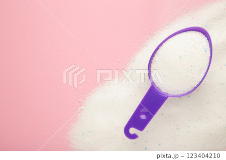 Laundry detergent powder for washing machine and plastic scoop for dosage. 123404210