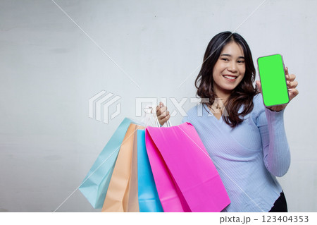 Beautiful Asian woman shopping using smartphone in navy blue suit on white background, advertising woman shopping online Beautiful Asian woman shopping using smartphone in navy blue suit on white background, advertising woman shopping online 123404353