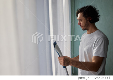 Steam cleaning curtains gives them a vibrant look, enhancing home 123404431