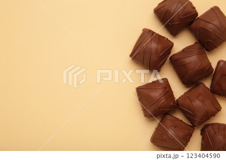 Chocolate candies on beige background. Top view 123404590