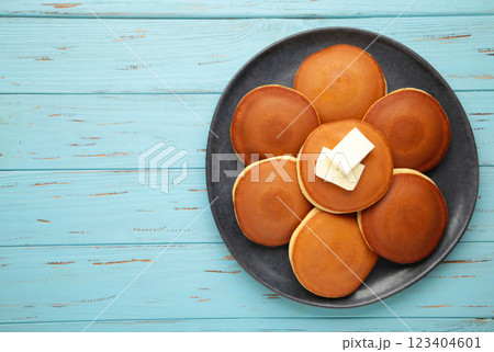 Homemade pancakes with butter in plate on blue background Homemade pancakes with butter in plate on blue background 123404601