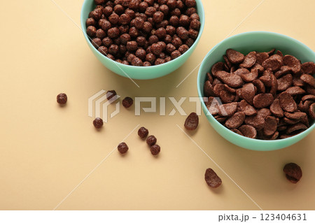 Different chocolate cereal corn in mint bowl on beige background. Different chocolate cereal corn in mint bowl on beige background. 123404631