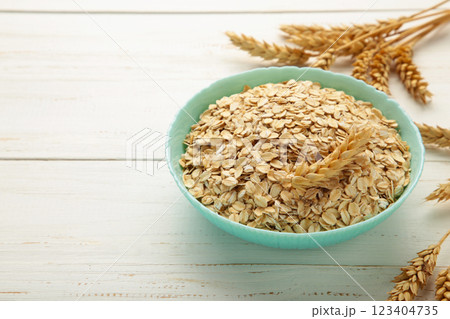 Oatmeal in bowl on white background. Healthy eating concept. Space for text 123404735