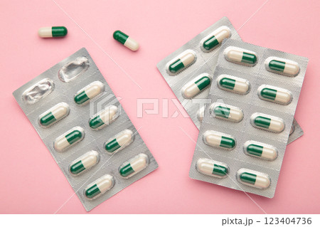 Medical blister packs with pills on pink background. Space for text 123404736