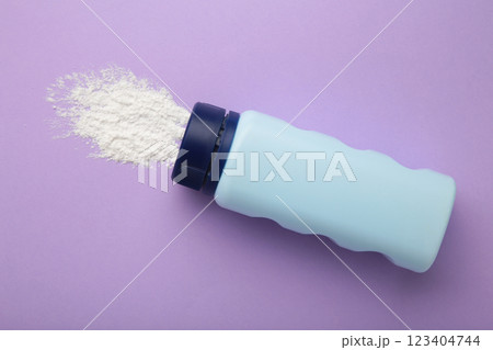 Baby powder on purple background. Baby cosmetics. Space for text Baby powder on purple background. Baby cosmetics. Space for text 123404744
