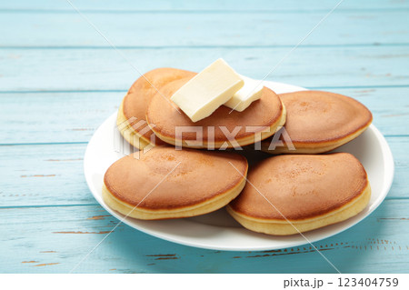 Homemade pancakes with butter in plate on blue background Homemade pancakes with butter in plate on blue background 123404759