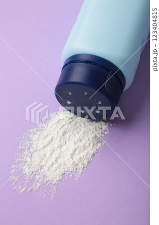 Baby powder on purple background. Baby cosmetics. Vertical photo Baby powder on purple background. Baby cosmetics. Vertical photo 123404815