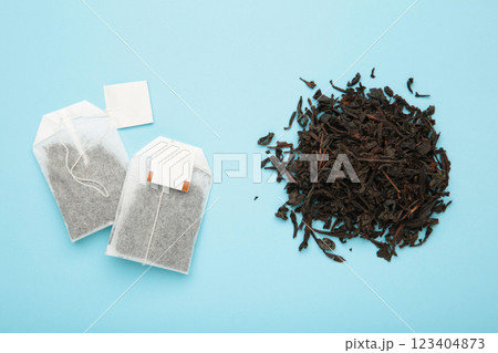 Tea bag and with dry tea leaves on blue background Tea bag and with dry tea leaves on blue background 123404873