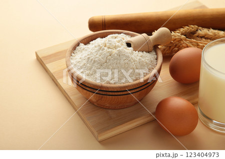 Ingredients for baking or cooking, egg flour, rolling pin butter, milk on a beige background Cookie pie or cake recipe. Ingredients for baking or cooking, egg flour, rolling pin butter, milk on a beige background Cookie pie or cake recipe. 123404973
