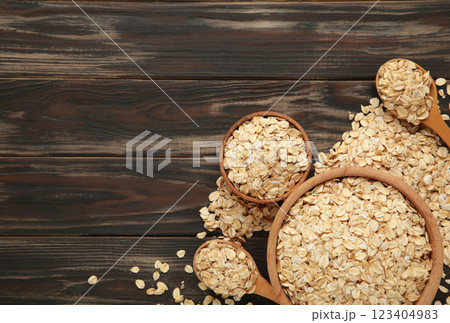 Oatmeal in bowl on brown background. Healthy eating concept. Space for text 123404983