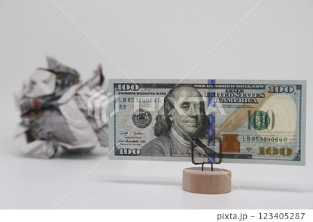 Banknote on the background of a crumpled piece of newspaper on a white background, fake news 123405287