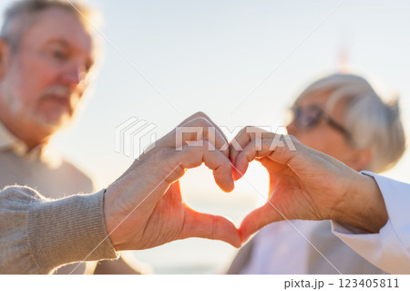 Love heart shape peace. Senior older couple making heart shape with their hands. Adult mature old husband wife showing heart sign. Happy pensioner family. I love you happy valentines day Love heart shape peace. Senior older couple making heart shape with their hands. Adult mature old husband wife showing heart sign. Happy pensioner family. I love you happy valentines day 123405811