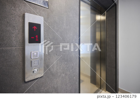 The modern elevator control panel features a display showcasing the current floor number The modern elevator control panel features a display showcasing the current floor number 123406179