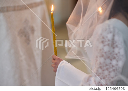 An Elegant Bride Holding a Candle During a Beautiful Wedding Ceremony Celebration Event An Elegant Bride Holding a Candle During a Beautiful Wedding Ceremony Celebration Event 123406208