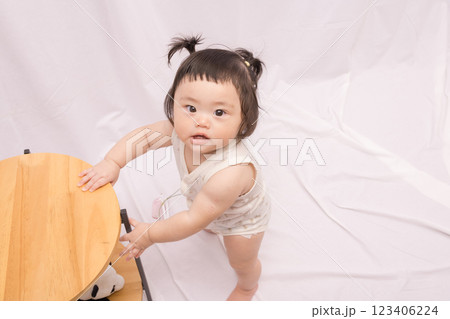 【テーブルでつかまり立ちをするツインテールの赤ちゃん】 【テーブルでつかまり立ちをするツインテールの赤ちゃん】 123406224