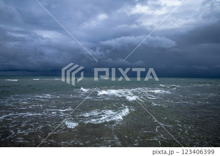 Dramatic seascape in dark colors. Dark sky with clouds over the stormy sea. 123406399