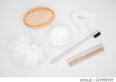 Natural bath accessories. Wooden hairbrush, cream, toothbrush, comb, loofah, hair ties Natural bath accessories. Wooden hairbrush, cream, toothbrush, comb, loofah, hair ties 123406450