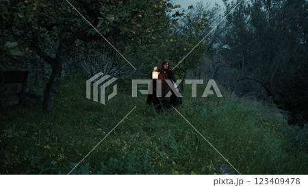 Lonely Woman Walks In The Forest At Night With A Lantern For Spiritual Rite Lonely Woman Walks In The Forest At Night With A Lantern For Spiritual Rite 123409478