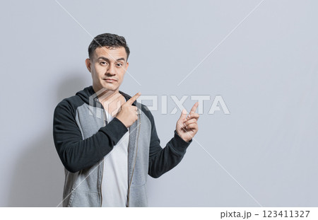 Smiling handsome man recommending something with fingers isolated, isolated people pointing fingers at something, Smiling person pointing fingers to the side 123411327