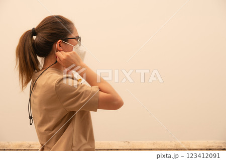 Rear view of Asian woman wearing an N95 mask for protect bad air pollution. 123412091