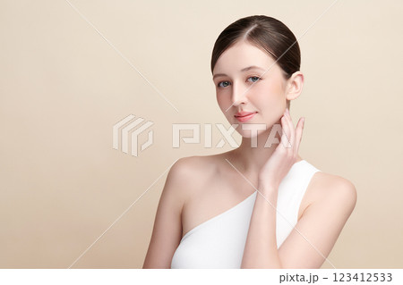 Beautiful young woman with clean fresh skin on beige background, Face care, Facial treatment, Cosmetology, beauty and spa, women portrait. Beautiful young woman with clean fresh skin on beige background, Face care, Facial treatment, Cosmetology, beauty and spa, women portrait. 123412533