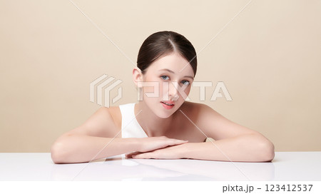 Beautiful young woman with clean fresh skin on beige background, Face care, Facial treatment, Cosmetology, beauty and spa, women portrait. Beautiful young woman with clean fresh skin on beige background, Face care, Facial treatment, Cosmetology, beauty and spa, women portrait. 123412537