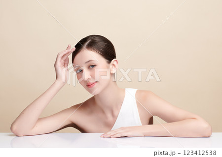 Beautiful young woman with clean fresh skin on beige background, Face care, Facial treatment, Cosmetology, beauty and spa, women portrait. 123412538