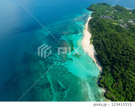 Transparent turquoise sea waters with coral reefs in Puka Shell Beach. White sands in Boracay, Philippines. Transparent turquoise sea waters with coral reefs in Puka Shell Beach. White sands in Boracay, Philippines. 123413553