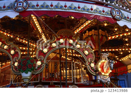 A Beautiful and Colorful Vintage Carousel Brightly Adorned with Illuminated Lights A Beautiful and Colorful Vintage Carousel Brightly Adorned with Illuminated Lights 123413986