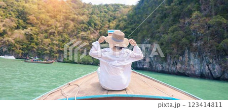 Happy Woman tourist in private longtail boat trip to koh Hong lagoon island at Krabi, Thailand. landmark, tropical destination, southeast Asia Travel, summer vacation, wanderlust and holiday concept Happy Woman tourist in private longtail boat trip to koh Hong lagoon island at Krabi, Thailand. landmark, tropical destination, southeast Asia Travel, summer vacation, wanderlust and holiday concept 123414811