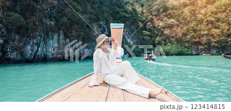 Happy Woman tourist in private longtail boat trip to koh Hong lagoon island at Krabi, Thailand. landmark, tropical destination, southeast Asia Travel, summer vacation, wanderlust and holiday concept 123414815