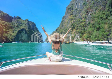 Woman tourist on boat trip, happy traveller relaxing at Pileh lagoon on Phi Phi island, Krabi, Thailand. Exotic landmark, destination Southeast Asia Travel, summer vacation and holiday concept Woman tourist on boat trip, happy traveller relaxing at Pileh lagoon on Phi Phi island, Krabi, Thailand. Exotic landmark, destination Southeast Asia Travel, summer vacation and holiday concept 123414833