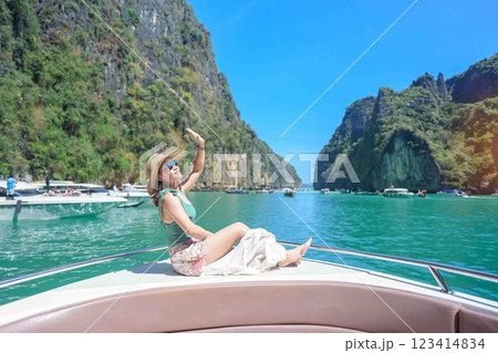 Woman tourist on boat trip, happy traveller relaxing at Pileh lagoon on Phi Phi island, Krabi, Thailand. Exotic landmark, destination Southeast Asia Travel, summer vacation and holiday concept 123414834