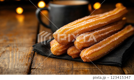 Fresh churros with golden brown exterior served with coffee 123415347