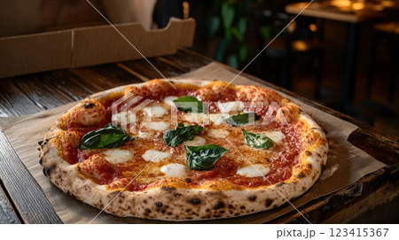 Freshly baked pizza with crispy crust and fresh basil leaves Freshly baked pizza with crispy crust and fresh basil leaves 123415367