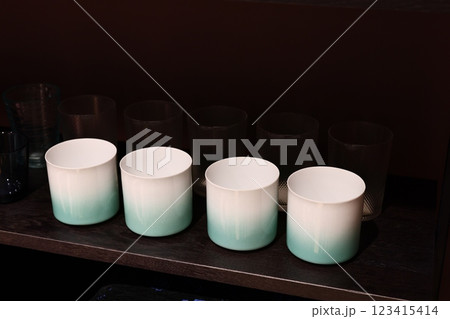 A Set of Elegant Gradient Mugs Captivatingly Displayed on a Beautiful Wooden Shelf 123415414
