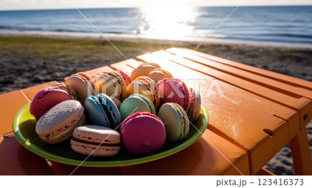 Colorful macarons on bright plate by beach at sunset Colorful macarons on bright plate by beach at sunset 123416373