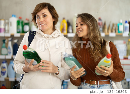 Mum with adult daughter purchases household chemicals in store, choose dishwashing detergent 123416868