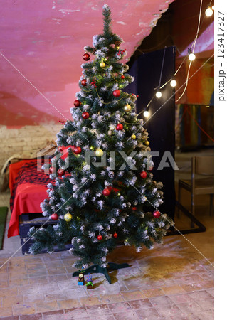 A beautifully decorated Festive Christmas Tree shining brightly in a Cozy Setting A beautifully decorated Festive Christmas Tree shining brightly in a Cozy Setting 123417327
