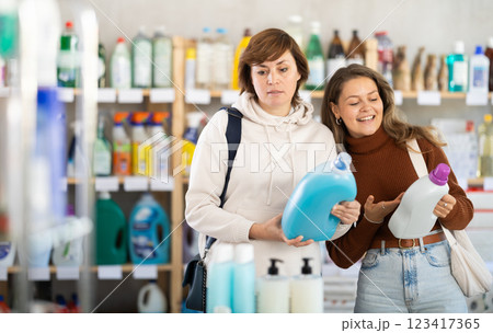 Two women choosing laundry detergent in department store 123417365