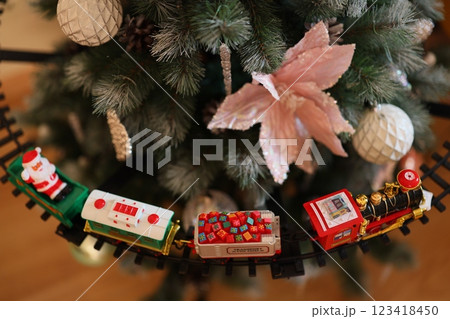 A Beautiful Festive Train Decoration Lining the Base of the Christmas Tree This Year 123418450