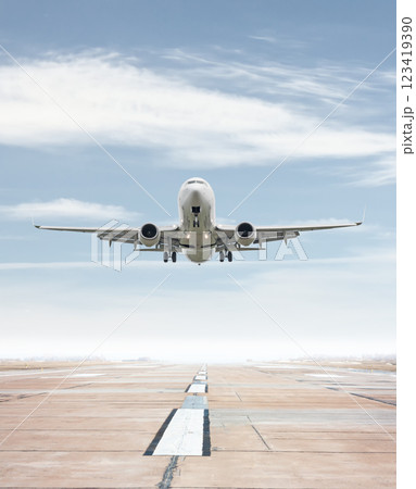 White passenger airliner take off from airport runway 123419390
