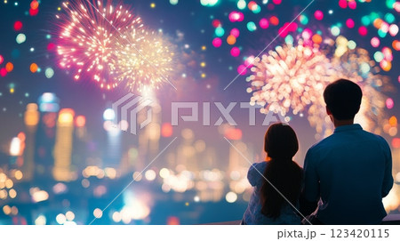 A family enjoys a stunning fireworks display over a vibrant city skyline during a festive evening celebration A family enjoys a stunning fireworks display over a vibrant city skyline during a festive evening celebration 123420115